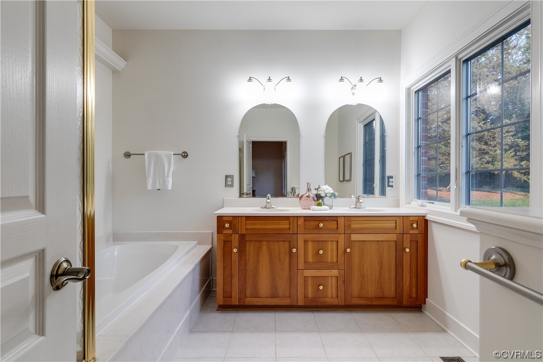12110 Iron Forge Drive Midlothian, VA 23113 - Photo 22 of 50 a spacious bathroom with a granite countertop sink mirror and bathtub