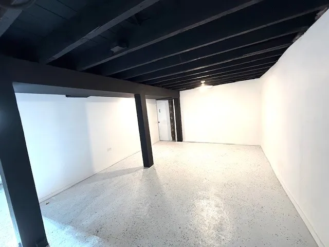 a view of big room with wooden floor and windows