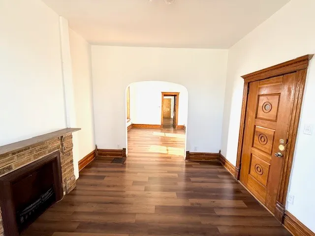 a view of a hallway with wooden floor