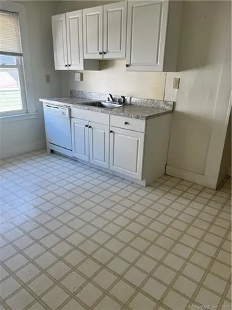 a kitchen with stainless steel appliances granite countertop a sink and cabinets