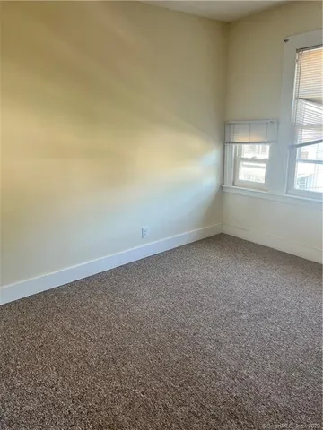 an empty room with a empty space and windows
