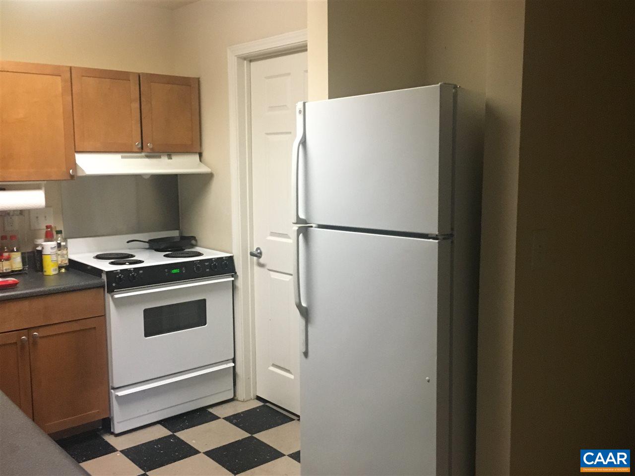 175 Yellowstone Drive, Unit 102 Charlottesville, VA 22903 - Photo 4 of 5 a white refrigerator freezer and a stove sitting inside of a kitchen