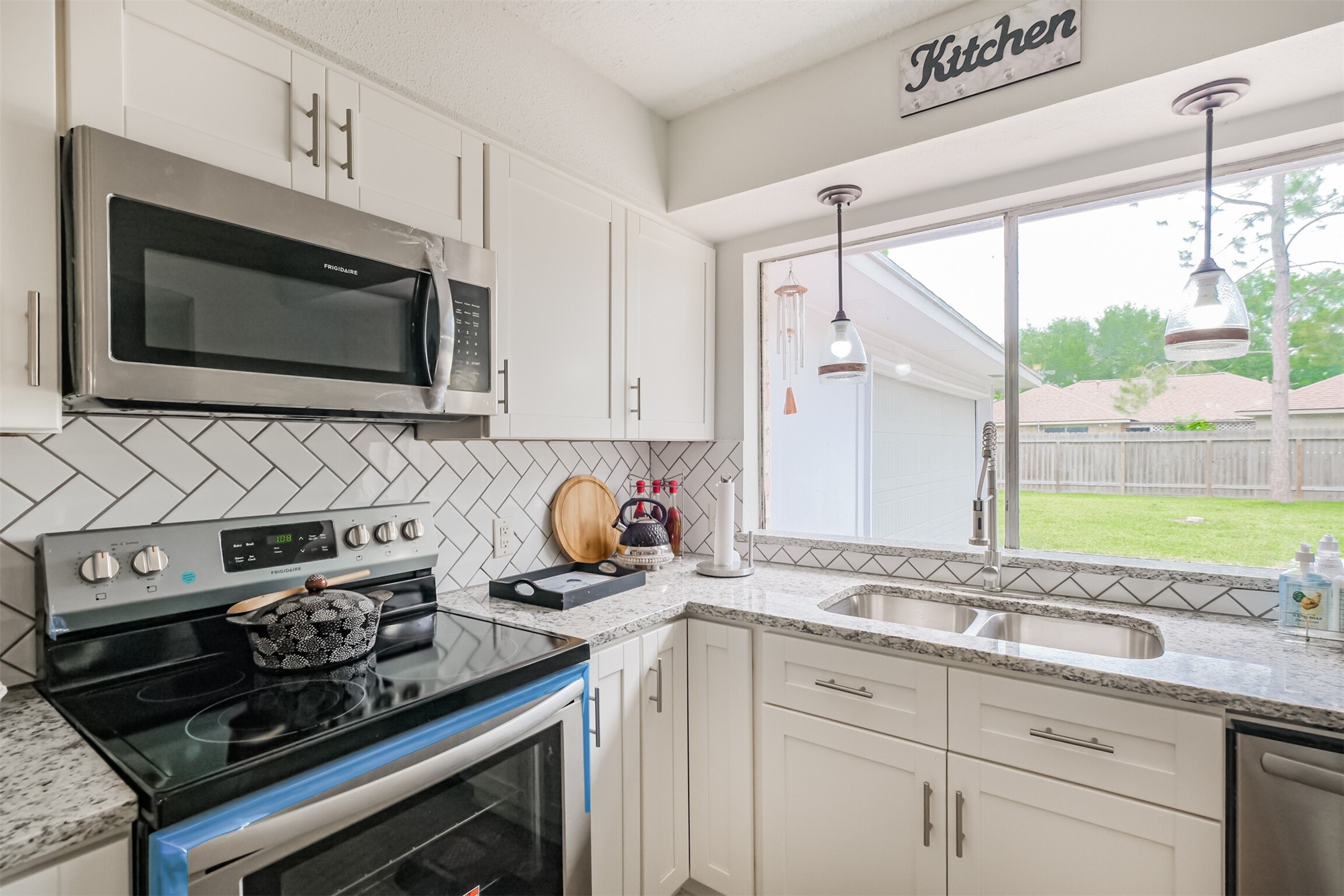 2705 Parrott Avenue Rosenberg, TX 77471 - Photo 10 of 37 a kitchen with stainless steel appliances a stove sink and microwave