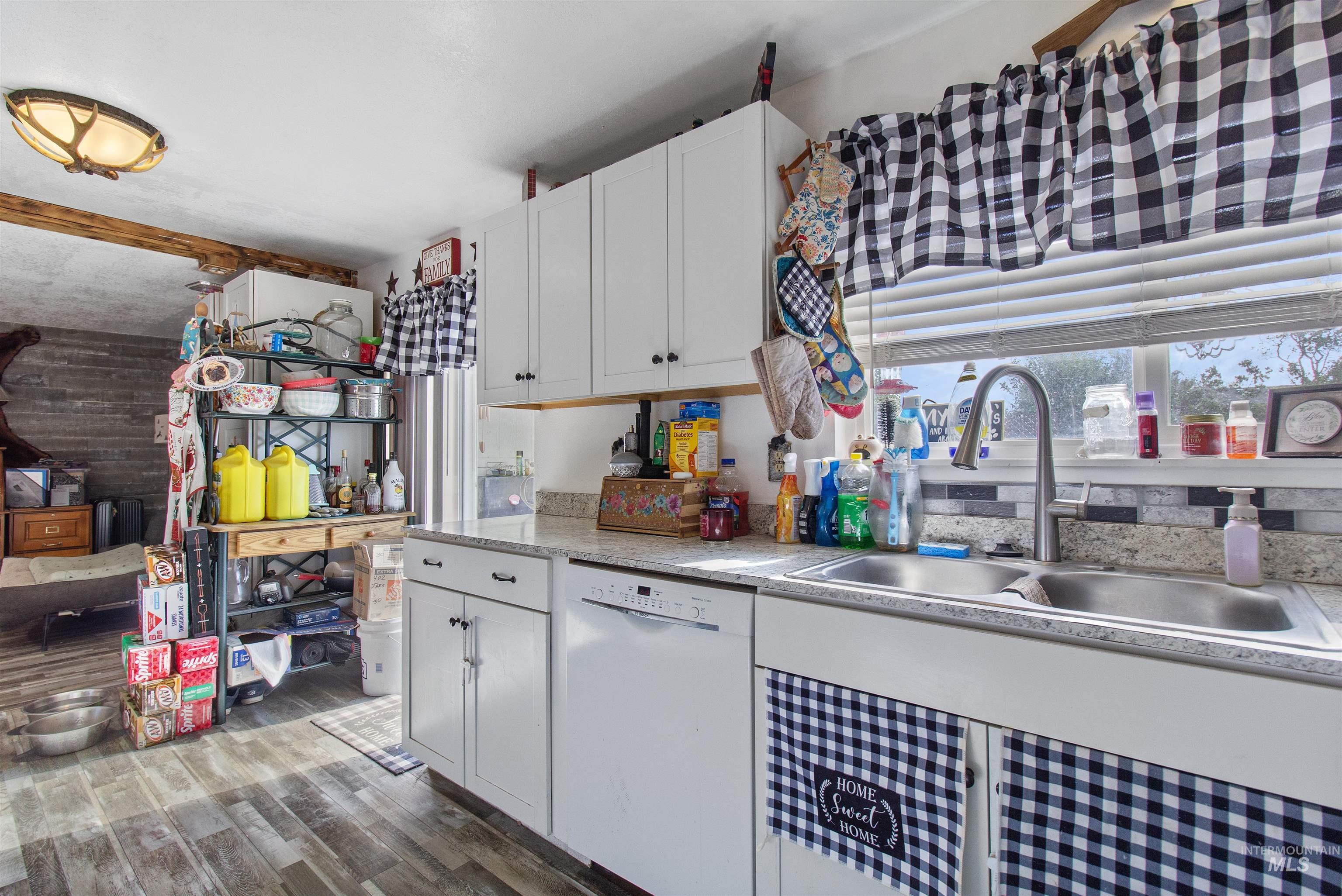 636 Main Street Hansen, ID 83334 - Photo 12 of 37 Kitchen featuring white cabinetry, stone-finish countertops, and wood-finish flooring