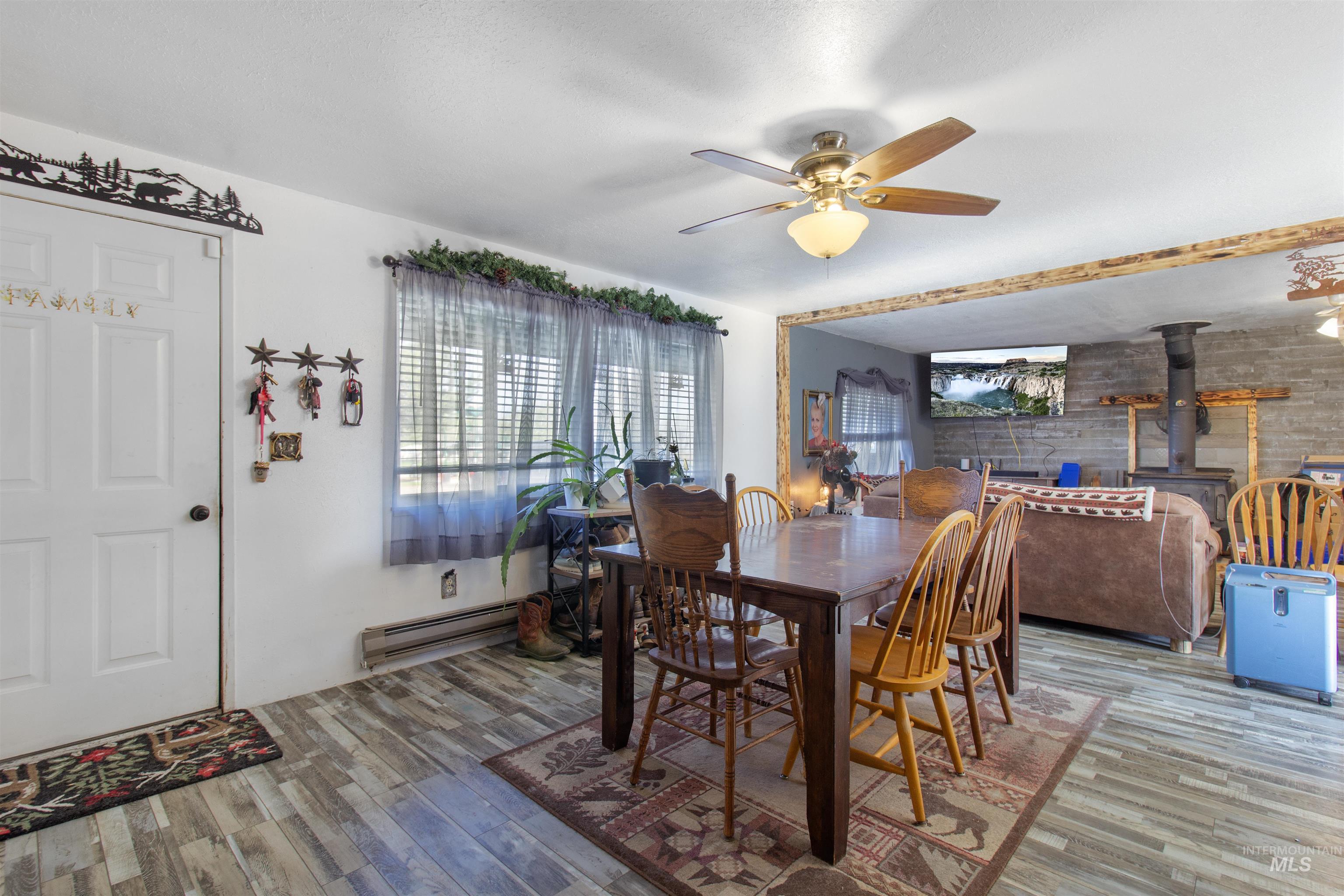 636 Main Street Hansen, ID 83334 - Photo 2 of 37 Dining area with wood-finish flooring, white walls, and a multi-pane window