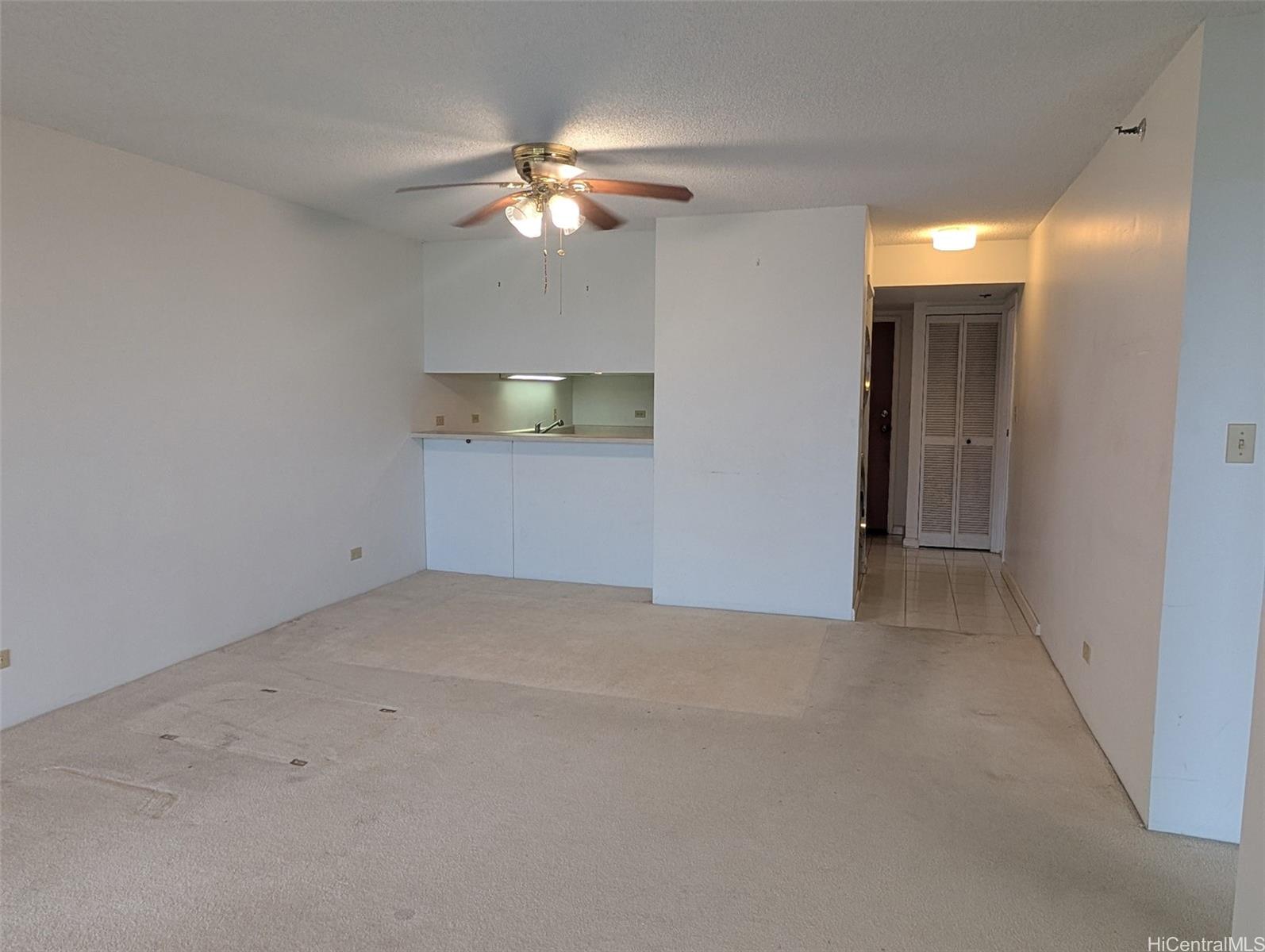 3130 Ala Ilima Street, Unit 10A Honolulu, HI 96818 - Photo 4 of 13 a view of an empty room with a chandelier fan