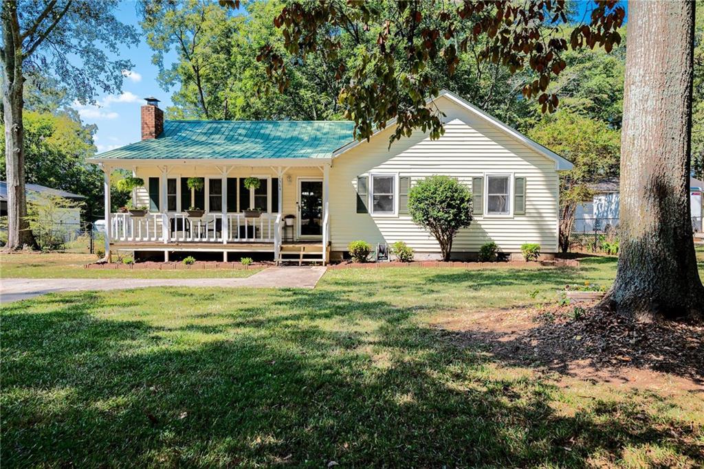 1384 Brookhaven Drive Monroe, GA 30656 - Photo 1 of 1 a front view of a house with a yard