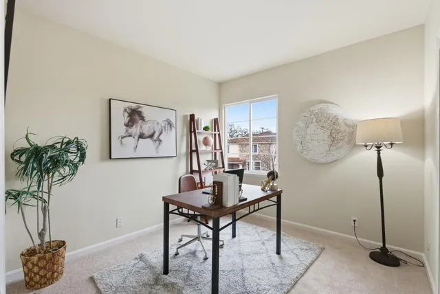 a workspace with furniture and a potted plant