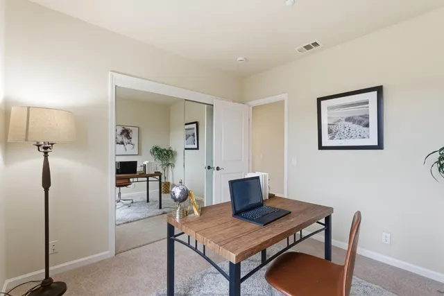 a view of a workspace with furniture