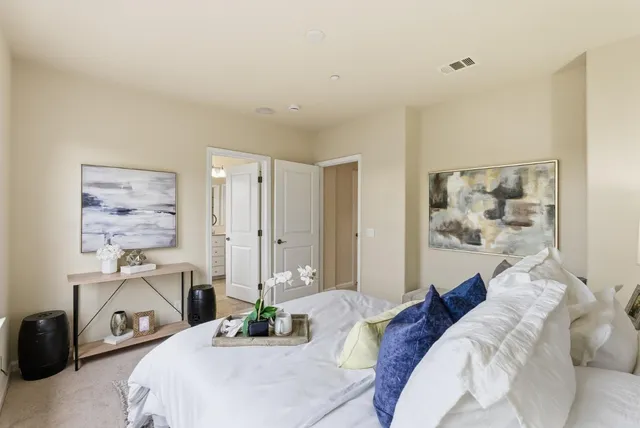 a bedroom with a bed a couch and a window