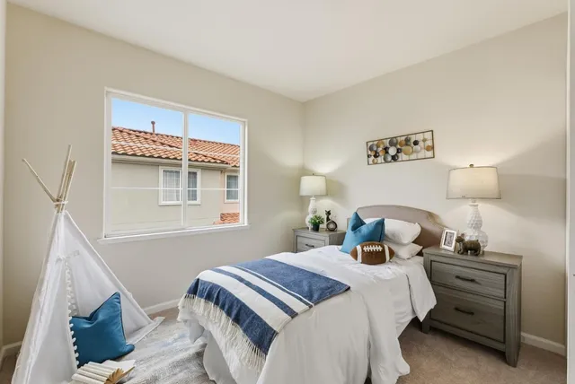 a bedroom with a bed and a night stand