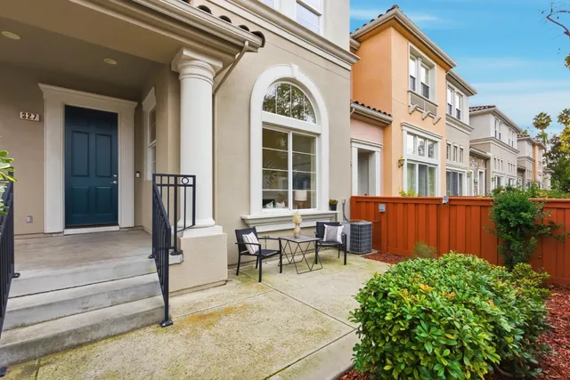 a view of a house with backyard and sitting area