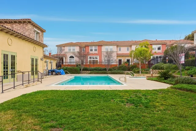 a view of yard with swimming pool and seating area