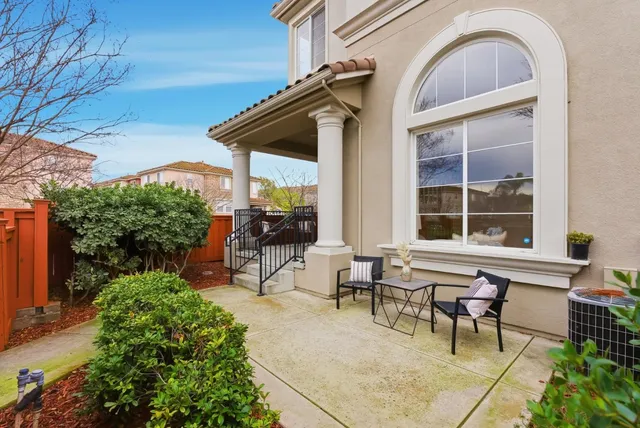 a view of patio with table and chairs under an umbrella