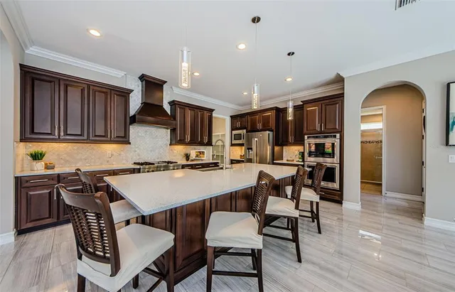 a kitchen with stainless steel appliances granite countertop a stove and a refrigerator
