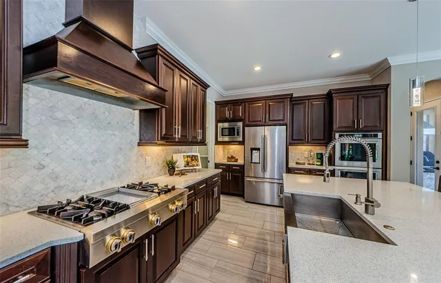 a kitchen with stainless steel appliances granite countertop a stove and a sink
