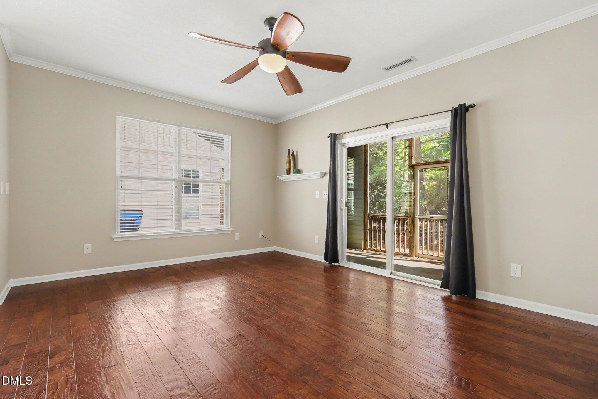 2409 Memory Ridge Drive Raleigh, NC 27606 - Photo 6 of 36 a view of an empty room with wooden floor and a window