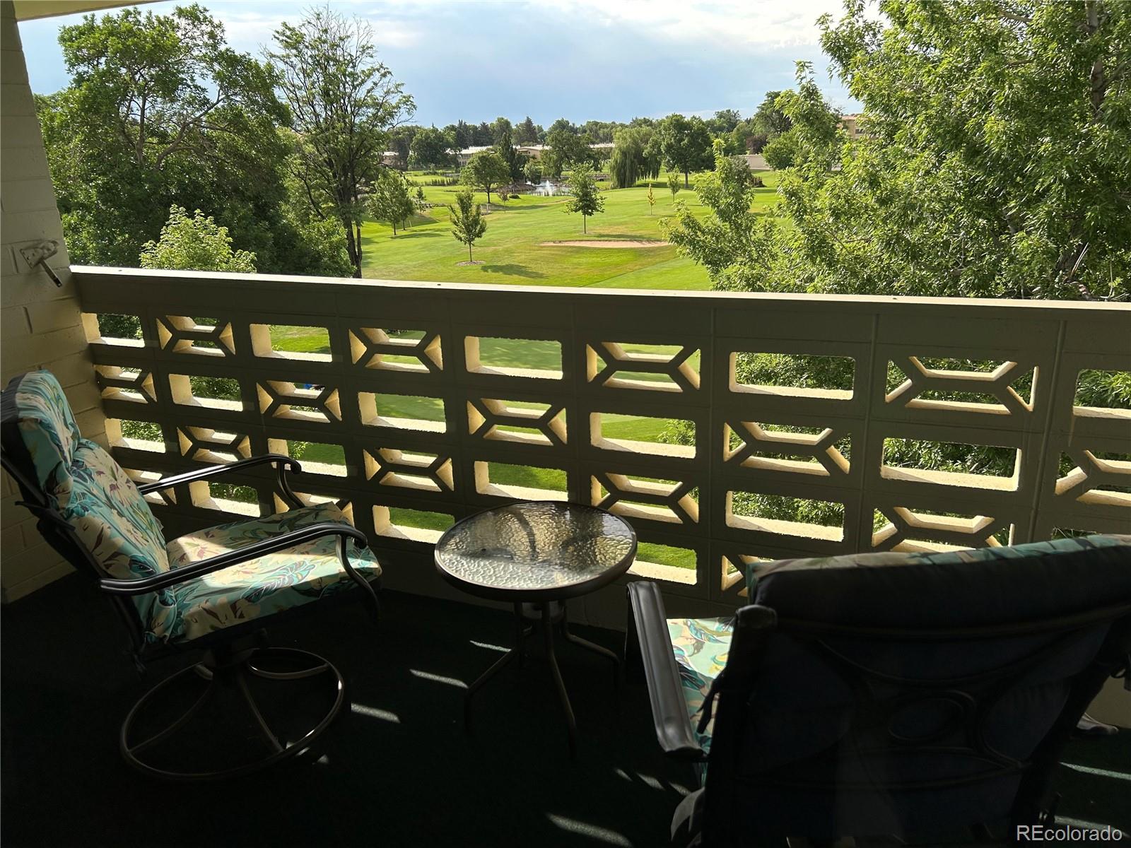 9180 Center Avenue, Unit 4D Denver, CO 80247 - Photo 12 of 19 a view of a balcony with chairs and a table