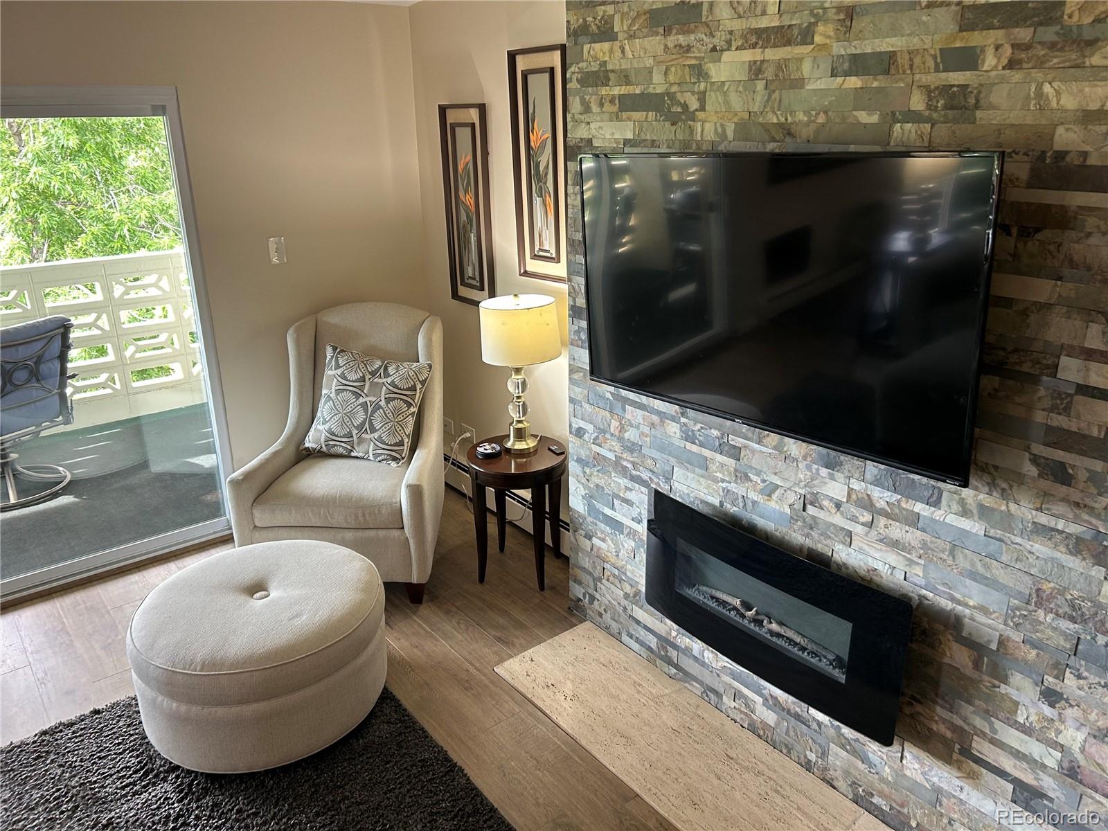 9180 Center Avenue, Unit 4D Denver, CO 80247 - Photo 7 of 19 a living room with furniture and a fireplace
