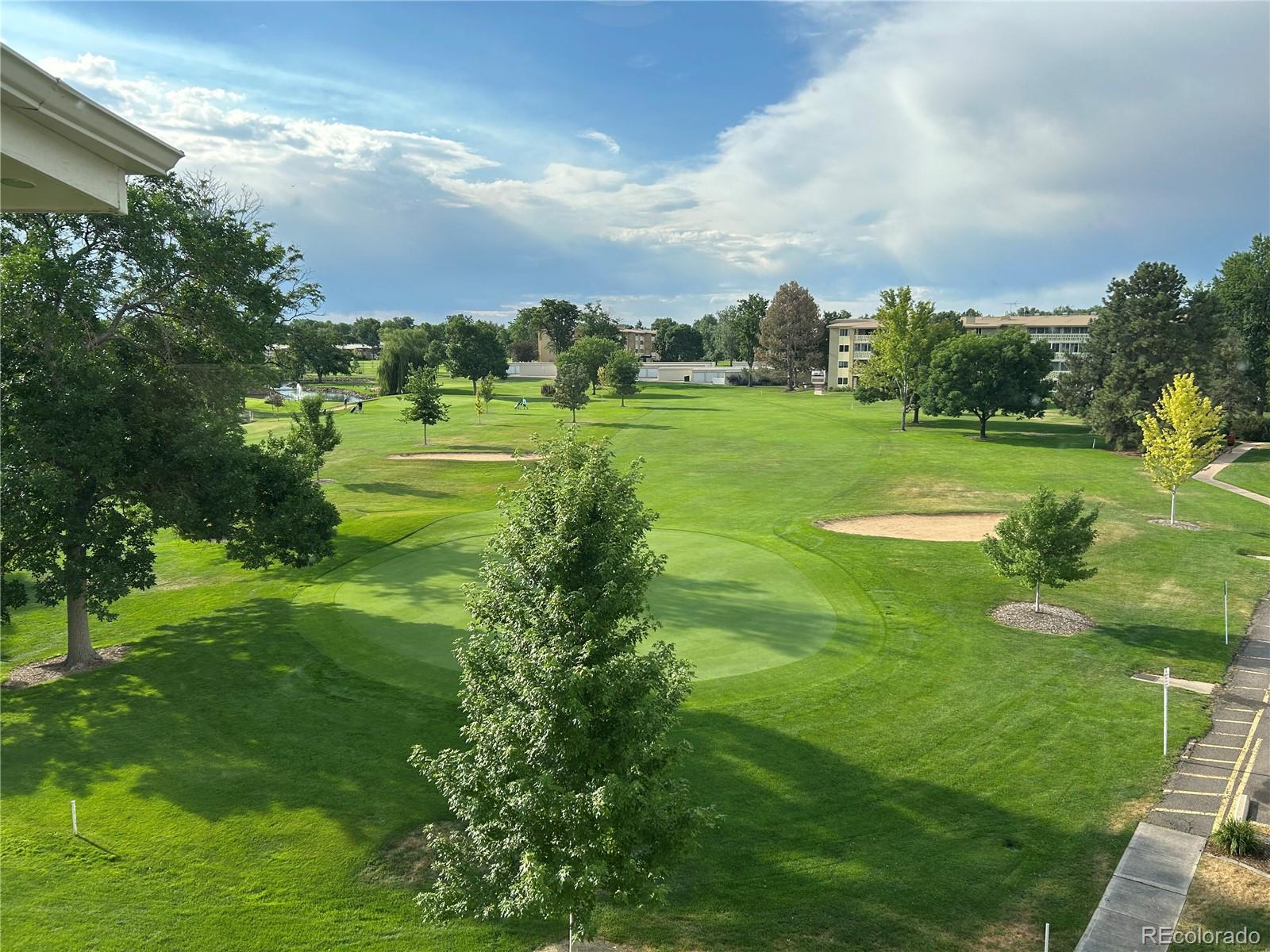 9180 Center Avenue, Unit 4D Denver, CO 80247 - Photo 10 of 19 a view of a golf course with a lake