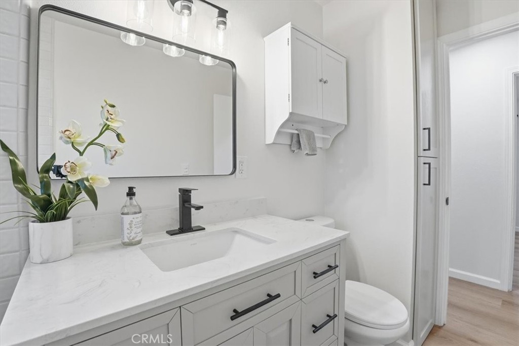 17751 Blythe Street Reseda, CA 91335 - Photo 12 of 23 a bathroom with a sink a toilet and mirror