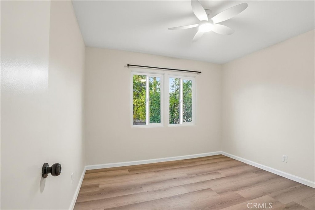 17751 Blythe Street Reseda, CA 91335 - Photo 13 of 23 an empty room with a window and a ceiling fan