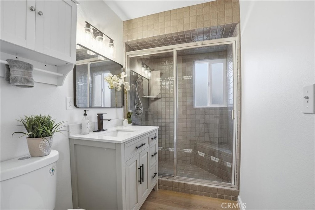 17751 Blythe Street Reseda, CA 91335 - Photo 14 of 23 a bathroom with a sink a mirror and a shower