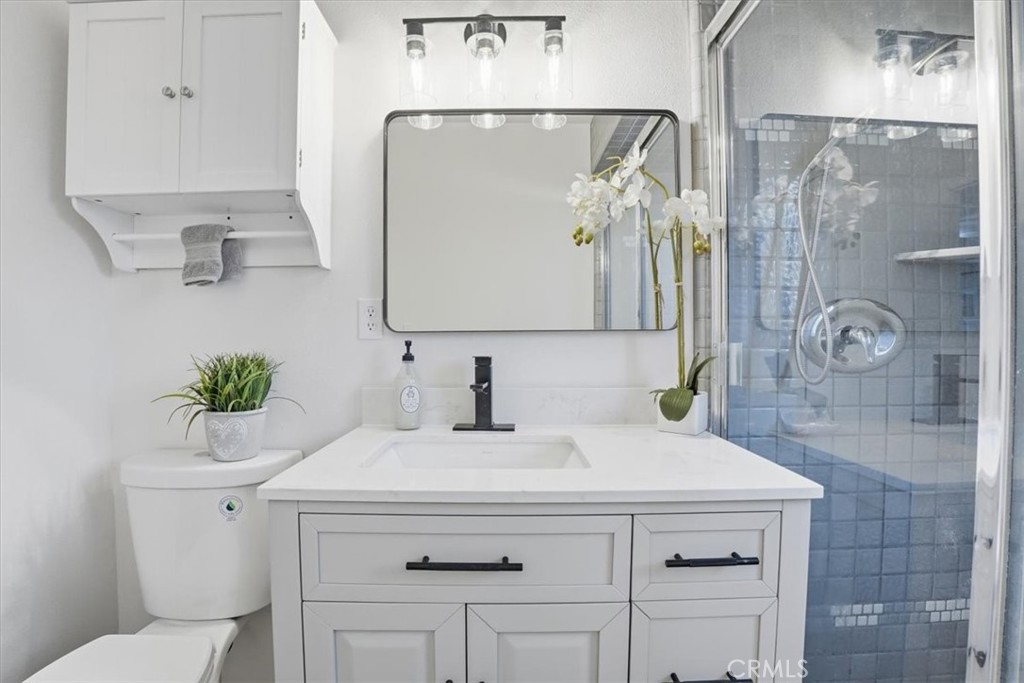 17751 Blythe Street Reseda, CA 91335 - Photo 15 of 23 a bathroom with a sink a toilet and shower