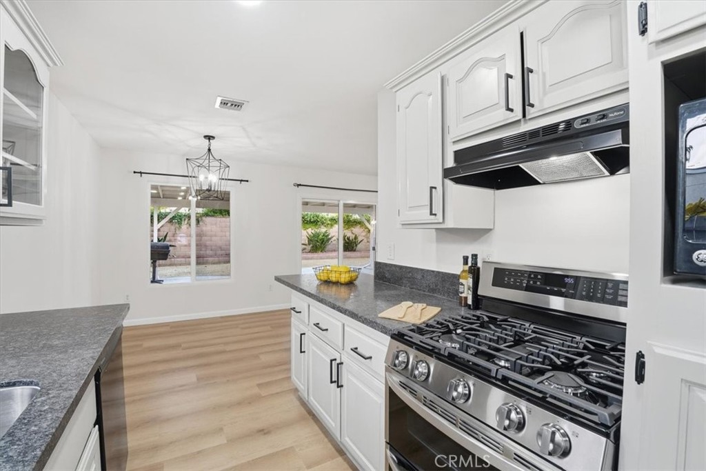 17751 Blythe Street Reseda, CA 91335 - Photo 7 of 23 a kitchen with stainless steel appliances granite countertop a stove and a sink
