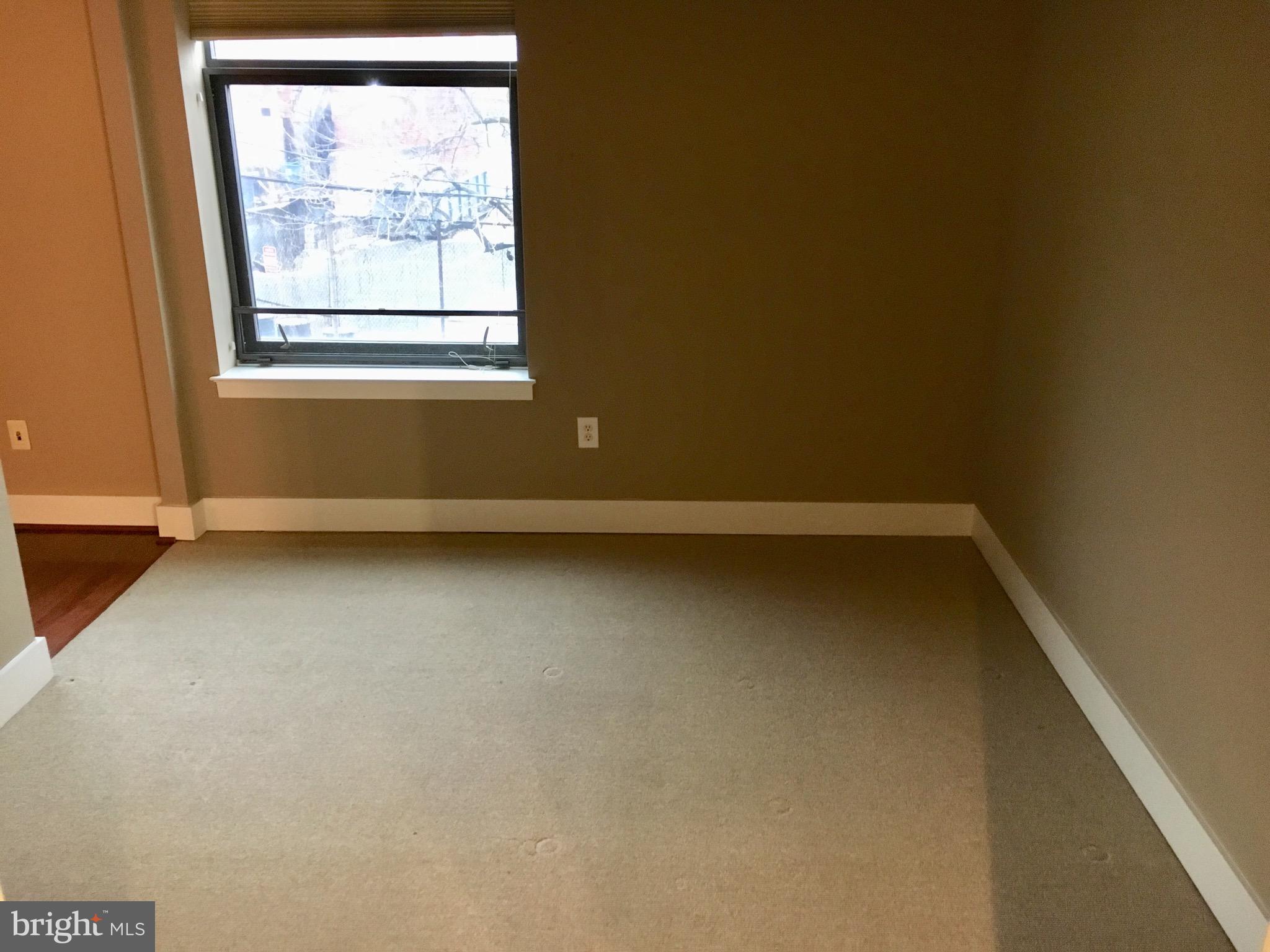 2301 Champlain Street Northwest, Unit 213 Washington, DC 20009 - Photo 24 of 40 an empty room with a window