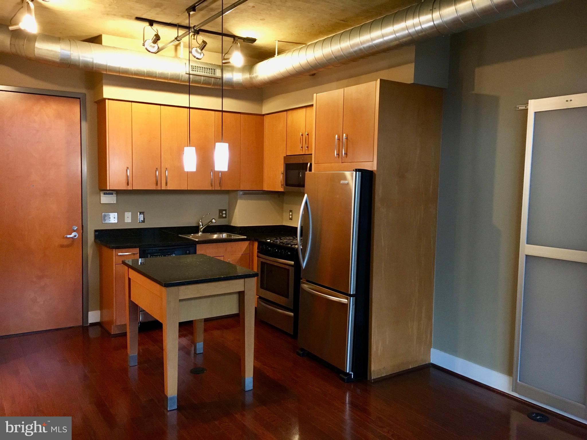 2301 Champlain Street Northwest, Unit 213 Washington, DC 20009 - Photo 6 of 40 a kitchen with stainless steel appliances granite countertop a refrigerator a sink and a stove
