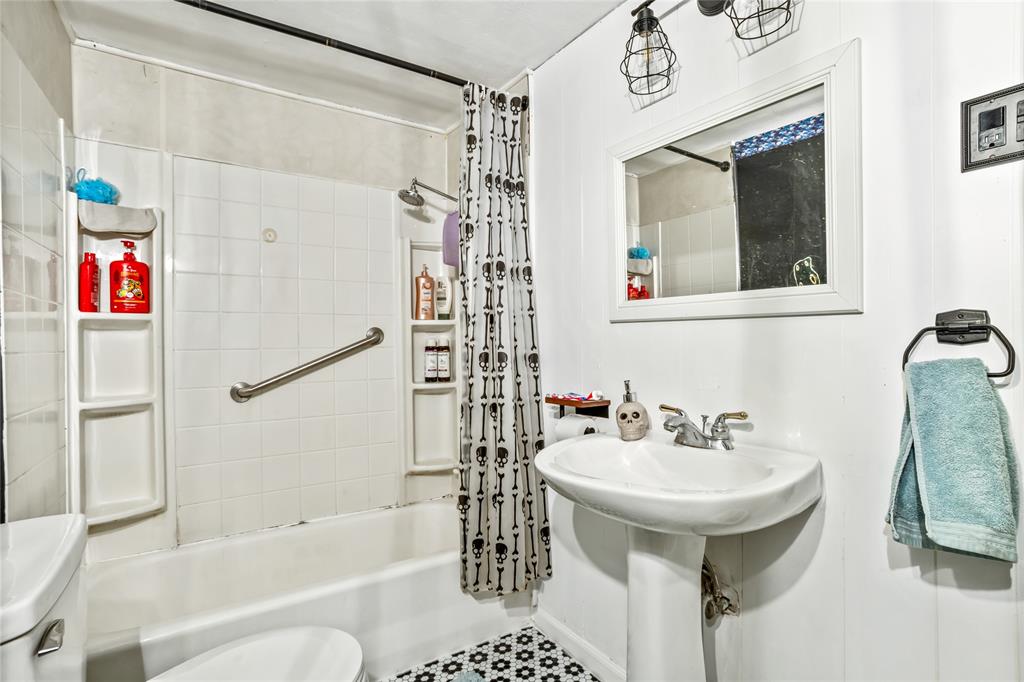 1641 Ben Davis Road Garland, TX 75040 - Photo 17 of 38 a bathroom with a sink toilet and shower