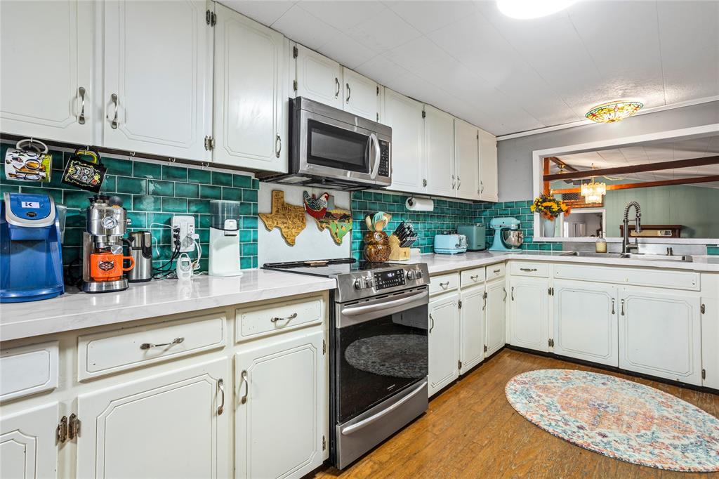 1641 Ben Davis Road Garland, TX 75040 - Photo 10 of 38 a kitchen with white cabinets stainless steel appliances and sink