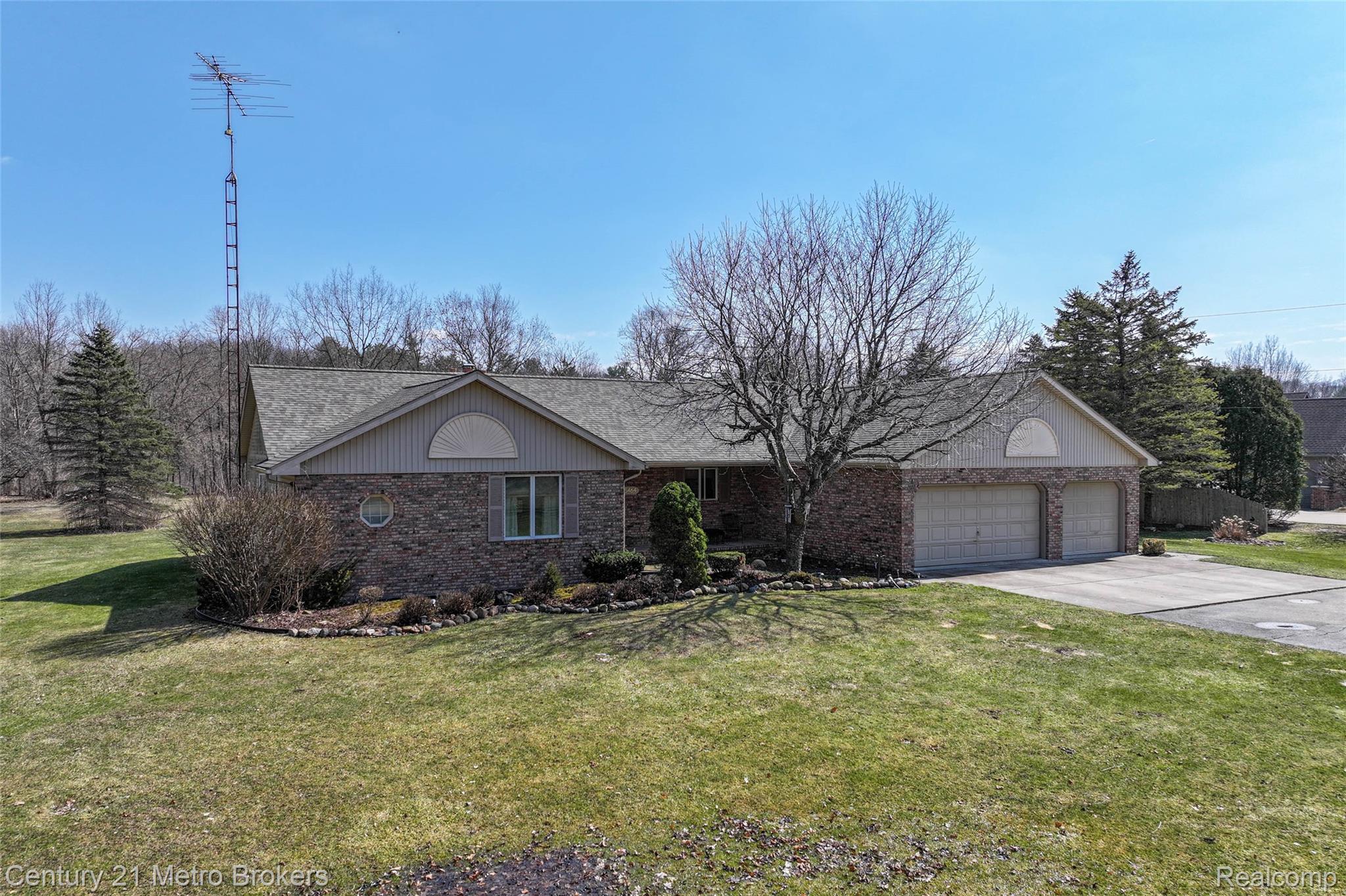 5464 North Seymour Road Flushing, MI 48433 - Photo 54 of 59 Ranch-style home with brick siding, a front yard, driveway, and an attached garage