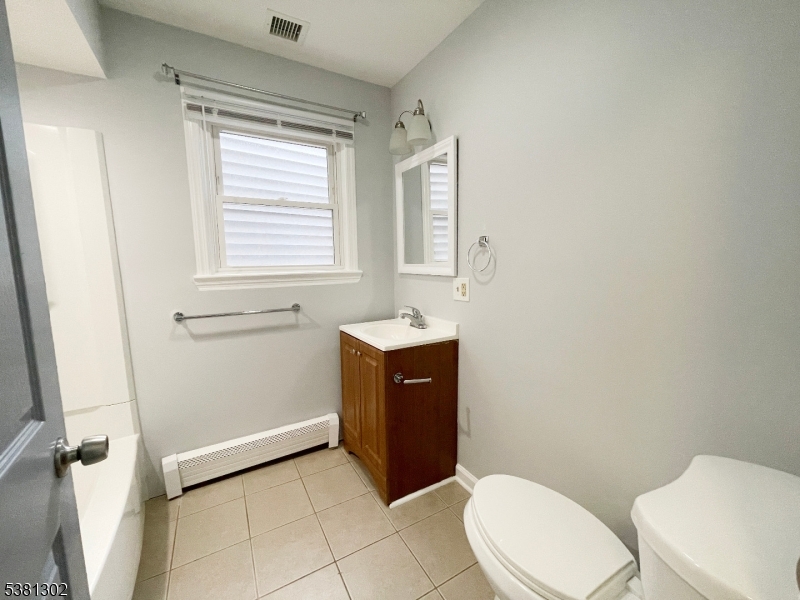31 Lakeside Boulevard, Unit A Hopatcong, NJ 07843 - Photo 13 of 24 a bathroom with a sink a toilet and mirror