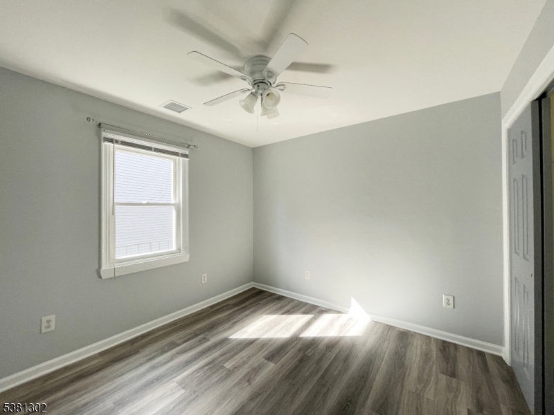 31 Lakeside Boulevard, Unit A Hopatcong, NJ 07843 - Photo 18 of 24 wooden floor in an empty room with a window