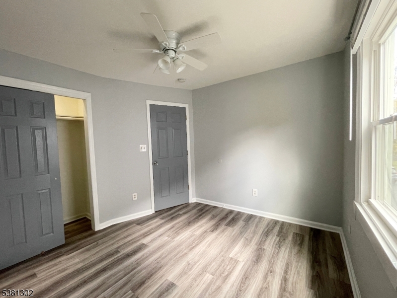31 Lakeside Boulevard, Unit A Hopatcong, NJ 07843 - Photo 19 of 24 wooden floor in an empty room with a window