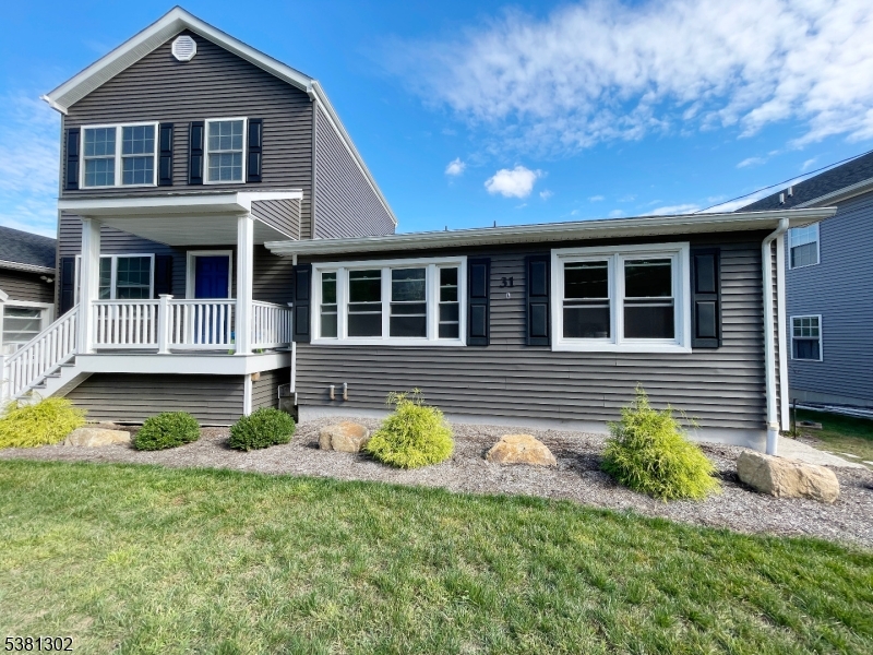 31 Lakeside Boulevard, Unit A Hopatcong, NJ 07843 - Photo 23 of 24 a front view of a house with a yard