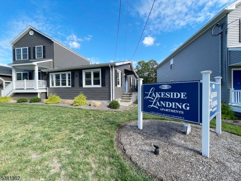 31 Lakeside Boulevard, Unit A Hopatcong, NJ 07843 - Photo 24 of 24 a wooden house with sign broad in front of it