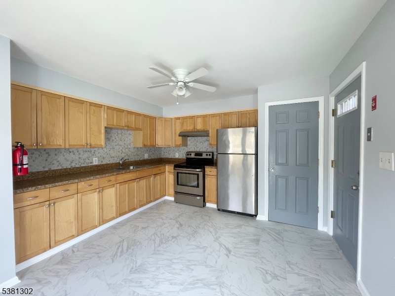 31 Lakeside Boulevard, Unit A Hopatcong, NJ 07843 - Photo 6 of 24 a large kitchen with stainless steel appliances granite countertop a refrigerator and a sink