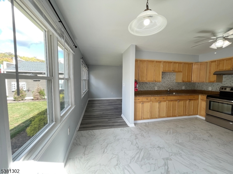 31 Lakeside Boulevard, Unit A Hopatcong, NJ 07843 - Photo 7 of 24 a large kitchen with granite countertop a stove a sink and a granite counter tops