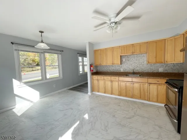 a view of a kitchen with a sink and a window
