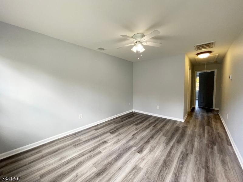 31 Lakeside Boulevard, Unit A Hopatcong, NJ 07843 - Photo 9 of 24 a view of an empty room and wooden floor
