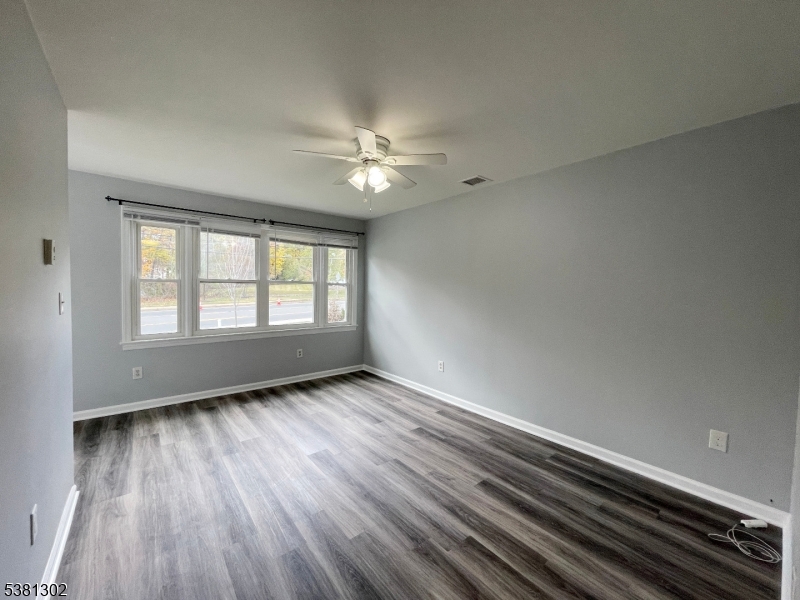 31 Lakeside Boulevard, Unit A Hopatcong, NJ 07843 - Photo 10 of 24 wooden floor in an empty room with a window