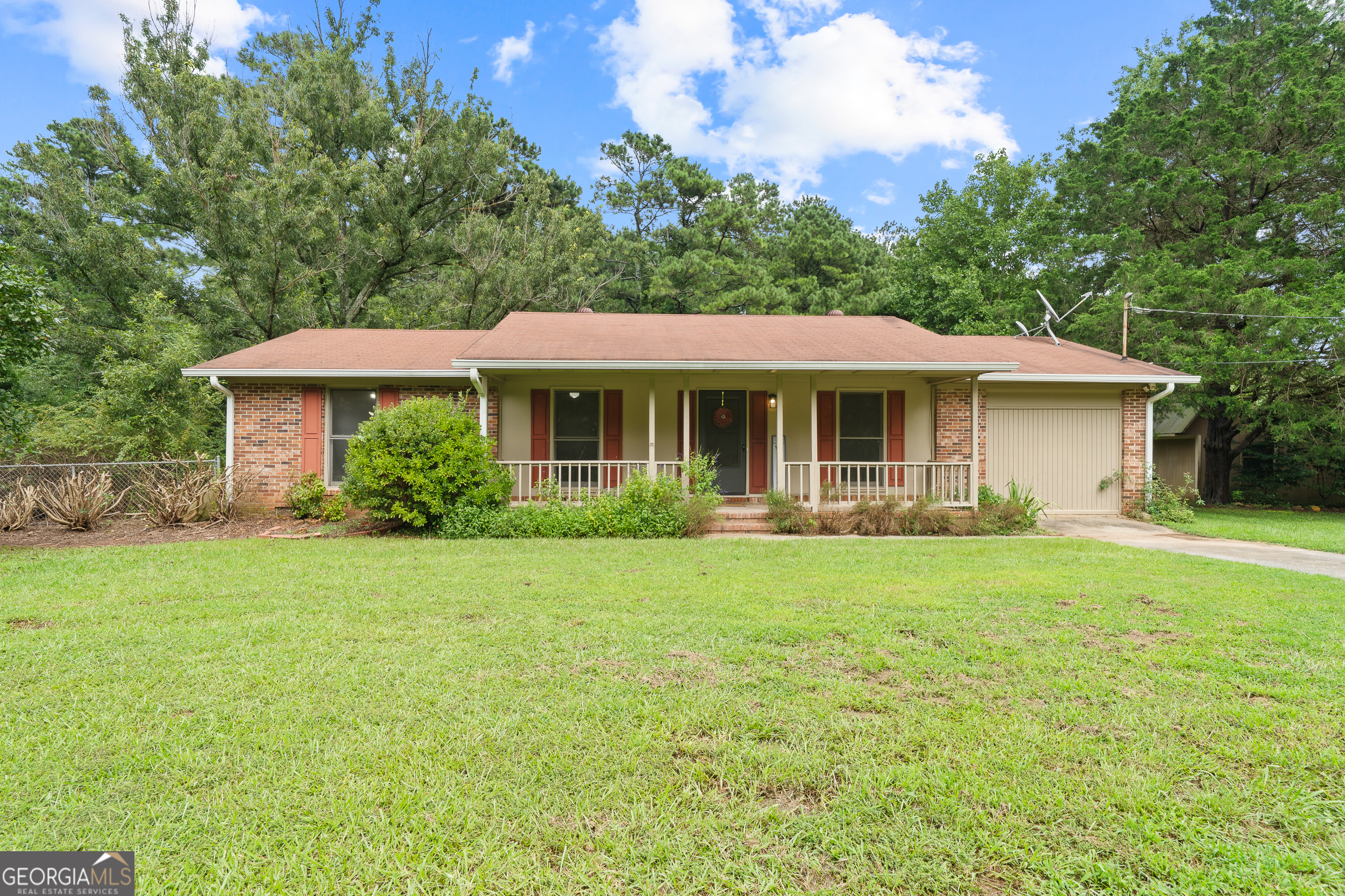 a front view of a house with a garden