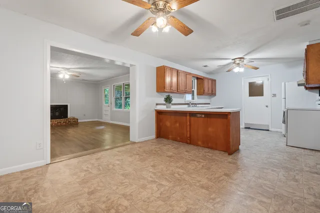 a view of kitchen with a sink and a refrigerator