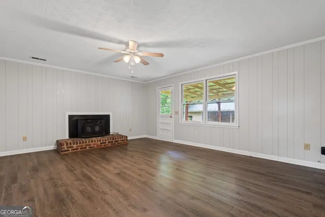 a view of an empty room with a fireplace