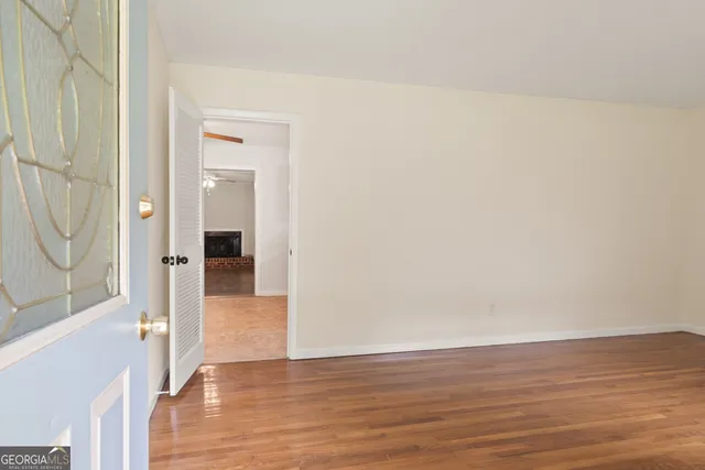 a view of a hallway with wooden floor