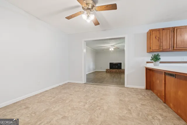 a bedroom with a large bed and a chandelier fan