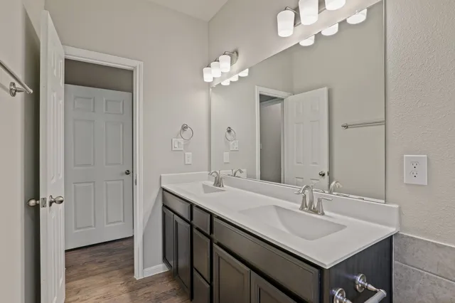 a bathroom with a sink double vanity and a mirror